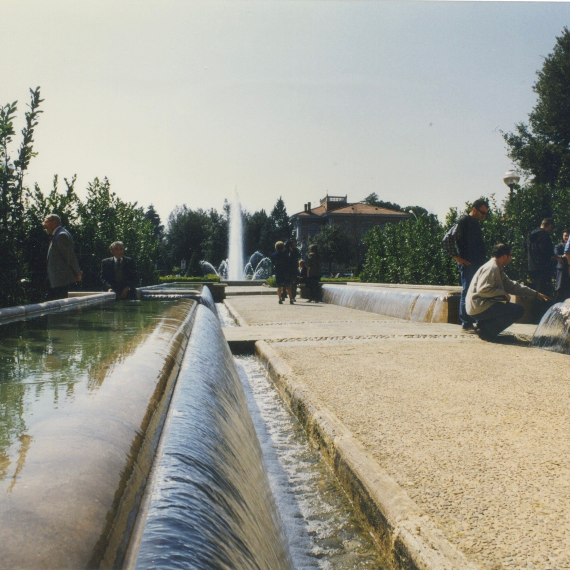 Public garden water channel with cascading water and central fountain