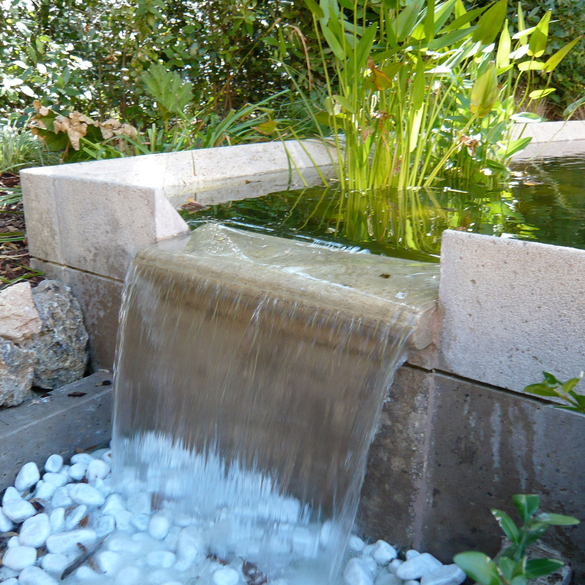 Stone water feature with sheet waterfall